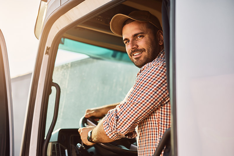 Young driver sitting in truck cabin